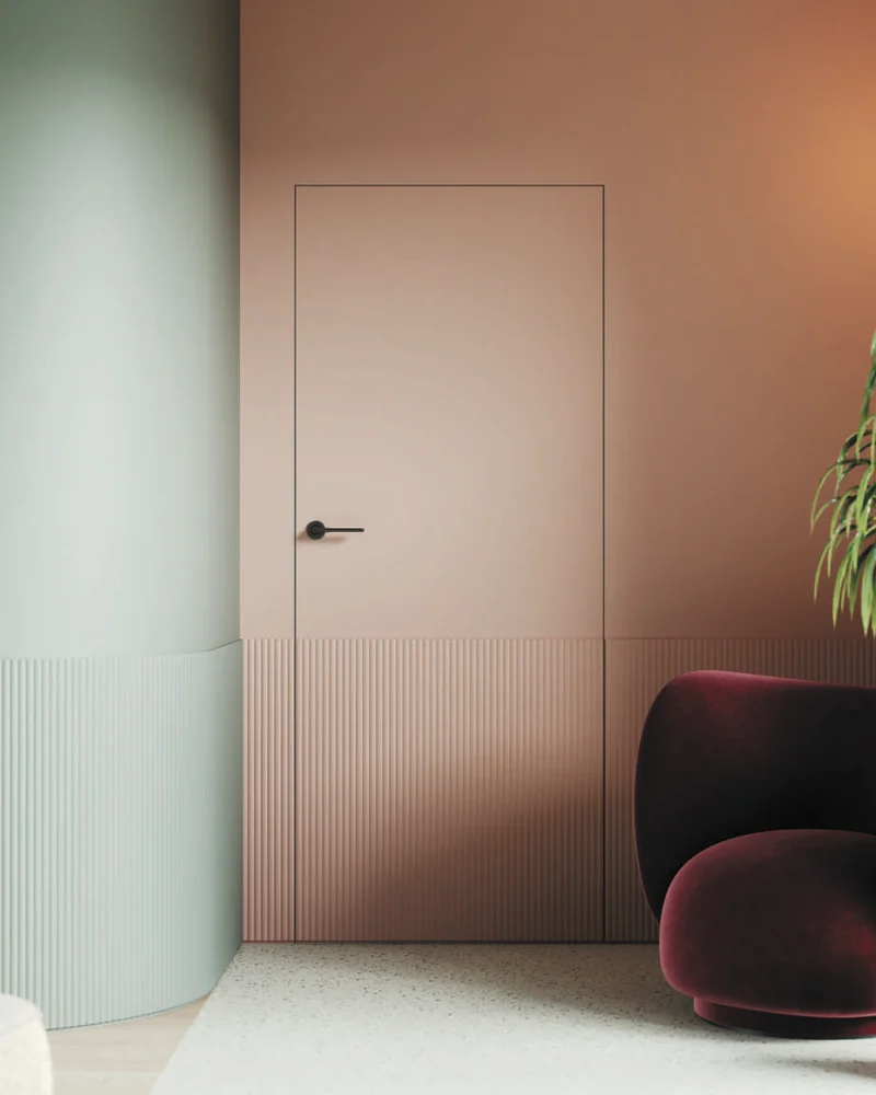 Ușă Porta Hide cu profile decorative, vopsită în aceeași culoare cu peretele, într-o cameră roz-teracotă